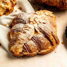 alt="Almond Croissant – buttery French pastry among the best bakery items loved by coffee lovers"